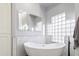 Relaxing bathroom with a freestanding tub and marble tile at 4575 E Encinas Ave, Gilbert, AZ 85234