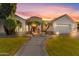 Stunning curb appeal! This home features a white exterior, lush landscaping, and a welcoming walkway at 4575 E Encinas Ave, Gilbert, AZ 85234