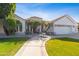 White stucco house with terracotta tile roof, palm trees, and a landscaped front yard at 4575 E Encinas Ave, Gilbert, AZ 85234