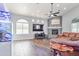 Bright living room featuring a large TV and a stone fireplace at 4575 E Encinas Ave, Gilbert, AZ 85234