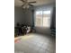 A bedroom featuring tile floors, a ceiling fan, a window, and toys in the room at 4730 W Northern Ave # 1076, Glendale, AZ 85301