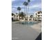 Community pool with palm trees, lounge chairs, and a scenic view of surrounding buildings at 4730 W Northern Ave # 1076, Glendale, AZ 85301