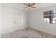 Bright bedroom with ceiling fan and a large window at 4947 E Adobe St, Mesa, AZ 85205