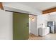 Hallway with barn door and view into laundry area at 4947 E Adobe St, Mesa, AZ 85205