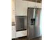 Stainless steel refrigerator and dishwasher are built into white cabinets at 4947 E Adobe St, Mesa, AZ 85205