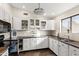 White kitchen cabinets, granite counters, and a window brighten the space at 4947 E Adobe St, Mesa, AZ 85205