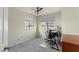 Home office with wood desk, window, and ceiling fan at 4947 E Adobe St, Mesa, AZ 85205