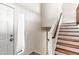 Clean and bright entryway with a wooden staircase leading upstairs at 4947 E Adobe St, Mesa, AZ 85205