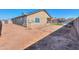 Side yard view of the house and backyard with a trampoline at 5175 W Warren Dr, Casa Grande, AZ 85194