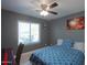 Bedroom with ceiling fan, large window, and workspace at 5175 W Warren Dr, Casa Grande, AZ 85194