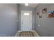 Bright entryway with gray walls, a white door, and a patterned rug at 5175 W Warren Dr, Casa Grande, AZ 85194