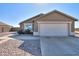 House exterior featuring a large garage and a rock pathway at 5175 W Warren Dr, Casa Grande, AZ 85194