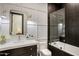 Modern bathroom with soaking tub, dark tile, and a floating vanity at 5712 E Calle Camelia --, Phoenix, AZ 85018