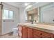 Modern bathroom with wood cabinets, updated vanity, and a large mirror at 5804 E Dallas St, Mesa, AZ 85205