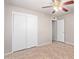 Bright bedroom with tile flooring, double door closet, and ceiling fan at 5804 E Dallas St, Mesa, AZ 85205