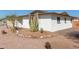 Side view of a house with a rock garden and cacti at 5804 E Dallas St, Mesa, AZ 85205