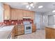 Well-equipped kitchen featuring wood cabinets and tile flooring at 5804 E Dallas St, Mesa, AZ 85205