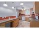 Kitchen features wood cabinets and red tile backsplash at 5804 E Dallas St, Mesa, AZ 85205