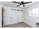 Bedroom with barn door and ceiling fan at 621 W Howe St, Tempe, AZ 85281