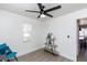 Bright bedroom with ceiling fan and built-in shelving at 621 W Howe St, Tempe, AZ 85281