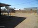 Large backyard with gravel and gated access at 676 N 7Th Pl, Coolidge, AZ 85128