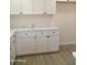 White shaker cabinets and quartz countertops in this updated kitchen at 676 N 7Th Pl, Coolidge, AZ 85128