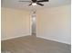 Living room features neutral walls, wood-look flooring, and access to other rooms at 676 N 7Th Pl, Coolidge, AZ 85128