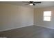 Spacious living room with neutral walls and ceiling fan at 676 N 7Th Pl, Coolidge, AZ 85128