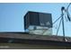 Rooftop air conditioning unit on a shingled roof at 676 N 7Th Pl, Coolidge, AZ 85128