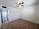 Cozy bedroom with neutral walls, plush carpet, and a ceiling fan for added comfort at 6815 W Reade Ave, Glendale, AZ 85303