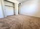 Spacious bedroom with an open closet showcasing ample storage and soft carpeting at 6815 W Reade Ave, Glendale, AZ 85303