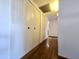 Hallway featuring wood floors and linen closet with paneled doors at 6815 W Reade Ave, Glendale, AZ 85303