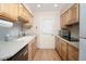 Galley kitchen with light wood cabinets and appliances at 6815 W Reade Ave, Glendale, AZ 85303