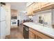 Kitchen with wood cabinets, double sink and a view of the dining area at 6815 W Reade Ave, Glendale, AZ 85303