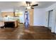 Spacious living room and kitchen featuring wood floors, ceiling fan, and wood cabinets at 6815 W Reade Ave, Glendale, AZ 85303