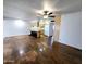 Open living room and kitchen featuring wood floors, ceiling fan, and wood cabinets at 6815 W Reade Ave, Glendale, AZ 85303