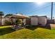 Backyard view showing patio, storage shed, and grassy area at 7004 N 11Th Way, Phoenix, AZ 85020