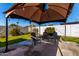 Backyard patio with covered seating area and small lawn at 7004 N 11Th Way, Phoenix, AZ 85020