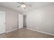 Simple bedroom with tile flooring, ceiling fan, and double door closet at 7004 N 11Th Way, Phoenix, AZ 85020