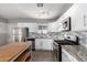 Modern kitchen with white cabinets and granite countertops at 7004 N 11Th Way, Phoenix, AZ 85020