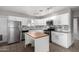 Modern kitchen with white cabinets, granite counters, and island at 7004 N 11Th Way, Phoenix, AZ 85020