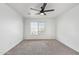 Bright bedroom with neutral carpeting and ceiling fan at 7235 E Norwood St, Mesa, AZ 85207