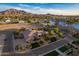 Scenic aerial view showcasing the house, lake, and surrounding mountains and neighborhood at 7456 S Brighton --, Queen Creek, AZ 85142