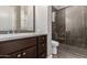 Bathroom featuring a large shower, dark cabinetry, and white countertops at 7456 S Brighton --, Queen Creek, AZ 85142