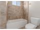 Well-lit bathroom featuring a shower-tub combo and tiled walls at 7456 S Brighton --, Queen Creek, AZ 85142