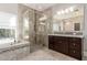 Modern bathroom featuring a glass shower, dark wood cabinets, and stone countertops at 7456 S Brighton --, Queen Creek, AZ 85142