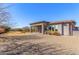 Expansive home exterior showcasing a covered patio and well-maintained landscaping at 7456 S Brighton --, Queen Creek, AZ 85142