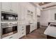 Kitchen featuring stainless steel appliances, white cabinets, and hardwood floors at 7456 S Brighton --, Queen Creek, AZ 85142