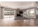 Well-lit living room showcasing a stone fireplace, modern ceiling fan, and large windows at 7456 S Brighton --, Queen Creek, AZ 85142