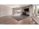 Bright living room featuring a stone fireplace, flatscreen television, and hardwood floors at 7456 S Brighton --, Queen Creek, AZ 85142